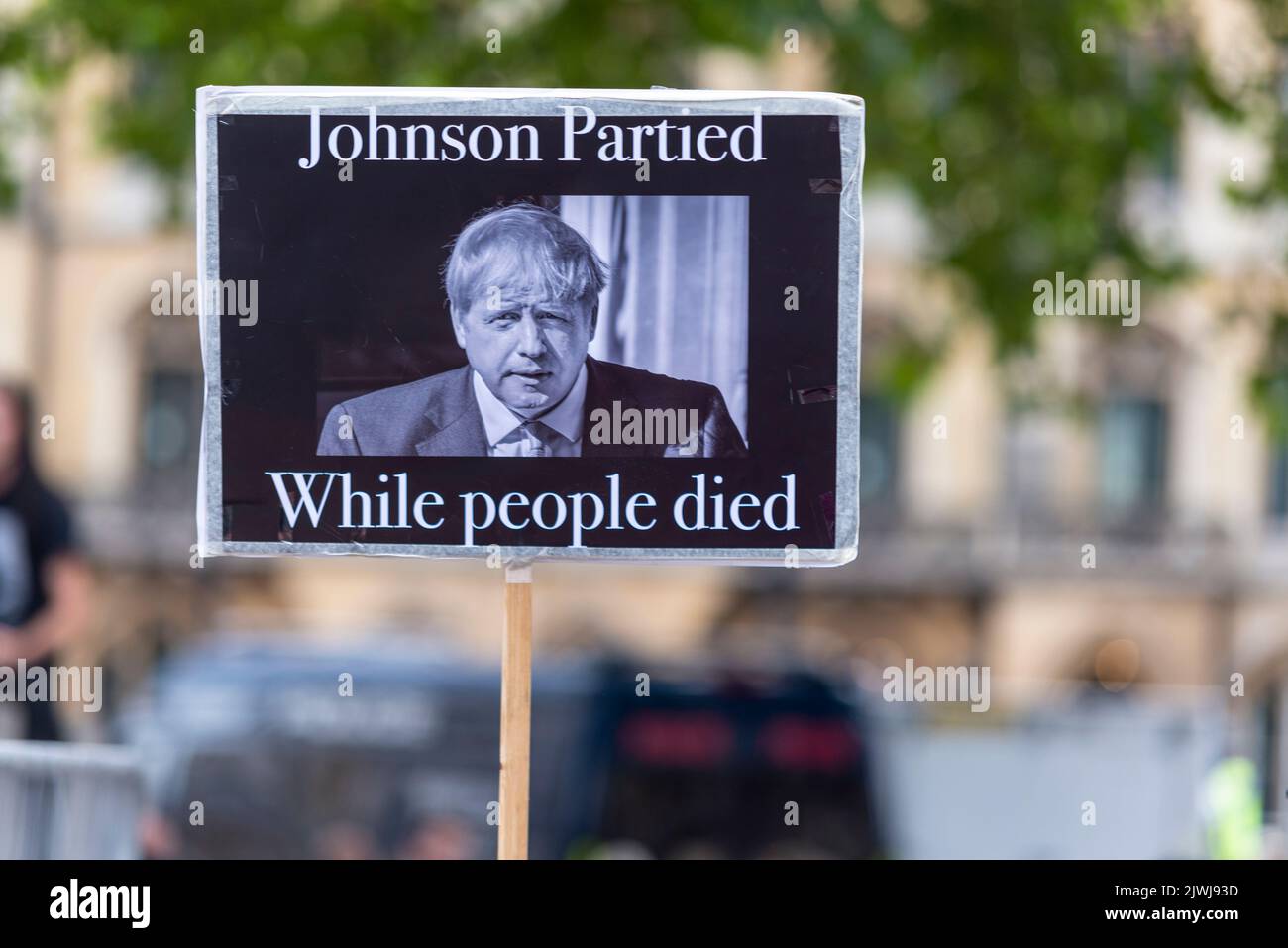 Protesters outside the Queen Elizabeth II Centre during the Conservative leadership announcement. COVID 19 Partygate placard Stock Photo