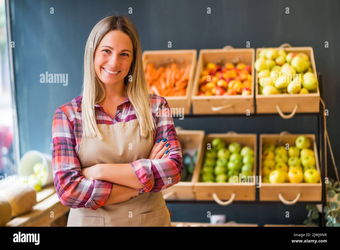 Portrait of happy food supermarket owner. Woman works in fruits and
