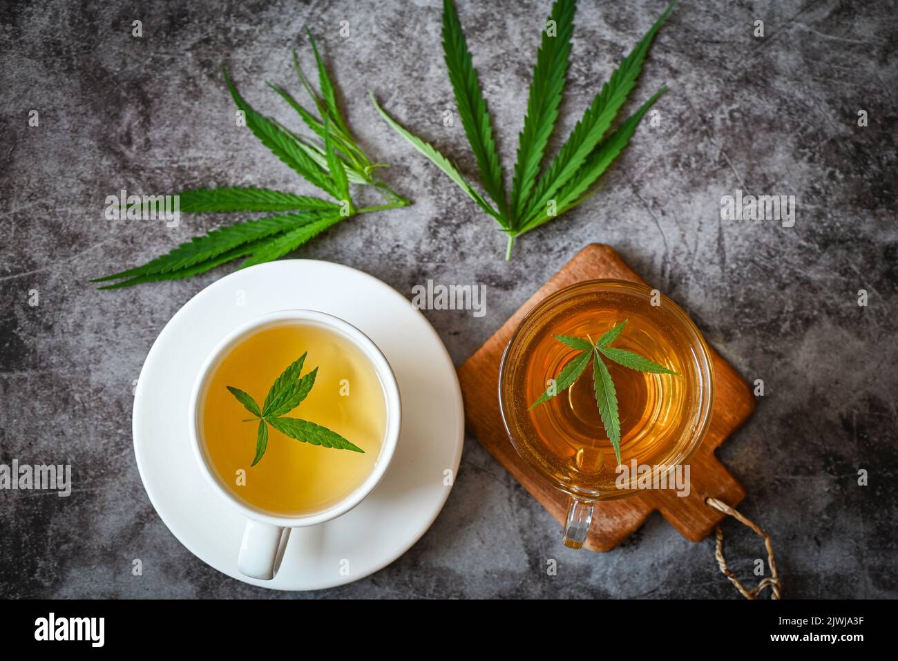 Cannabis tea herbal on tea cup with cannabis leaf marijuana leaves herb, health tea with hemp leaf plant THC CBD herbs food and medical - top view Stock Photo