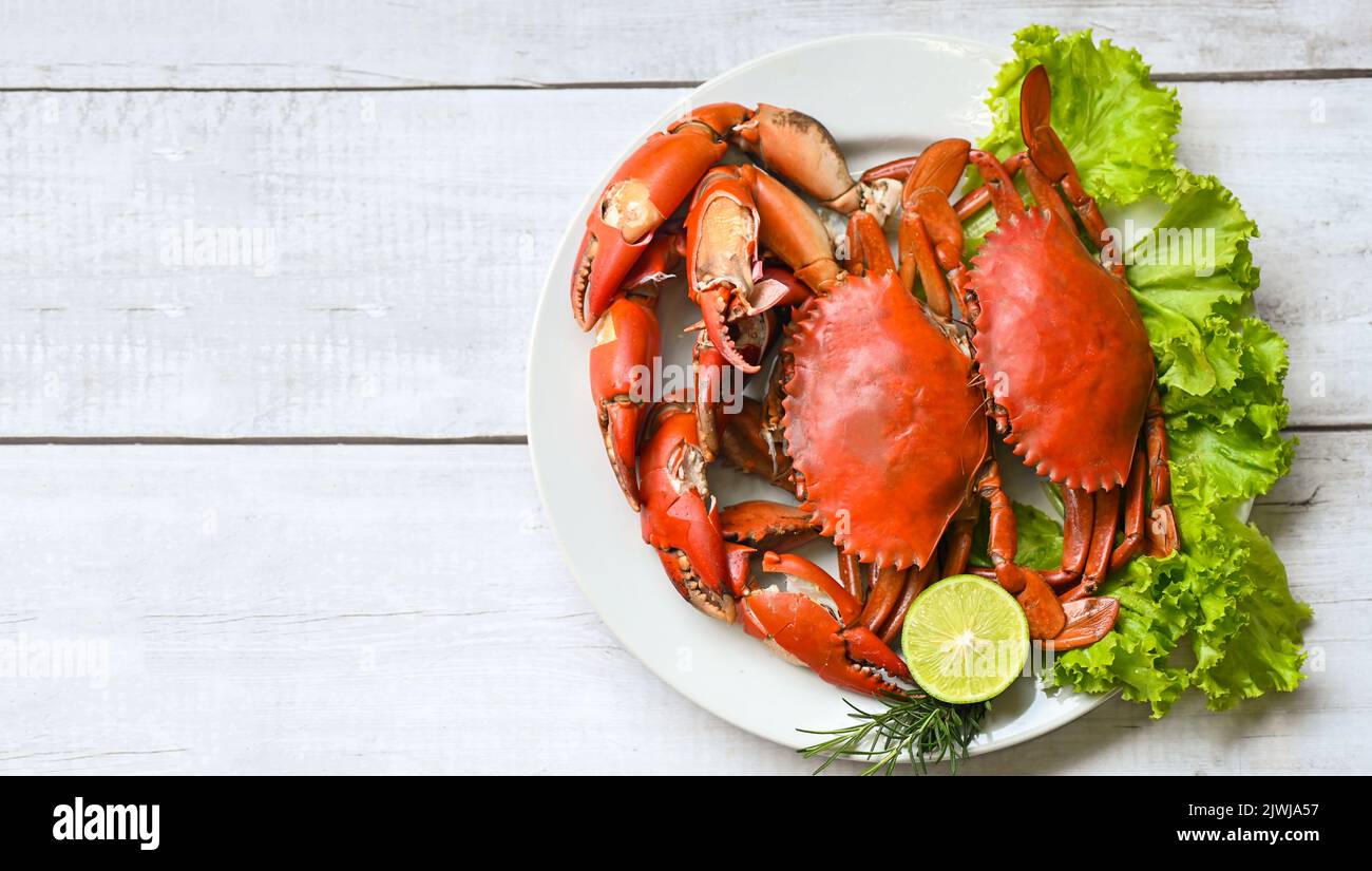 seafood crab cooking food boiled or steamed crab red in the seafood restaurant, fresh crab on white plate background - top view Stock Photo