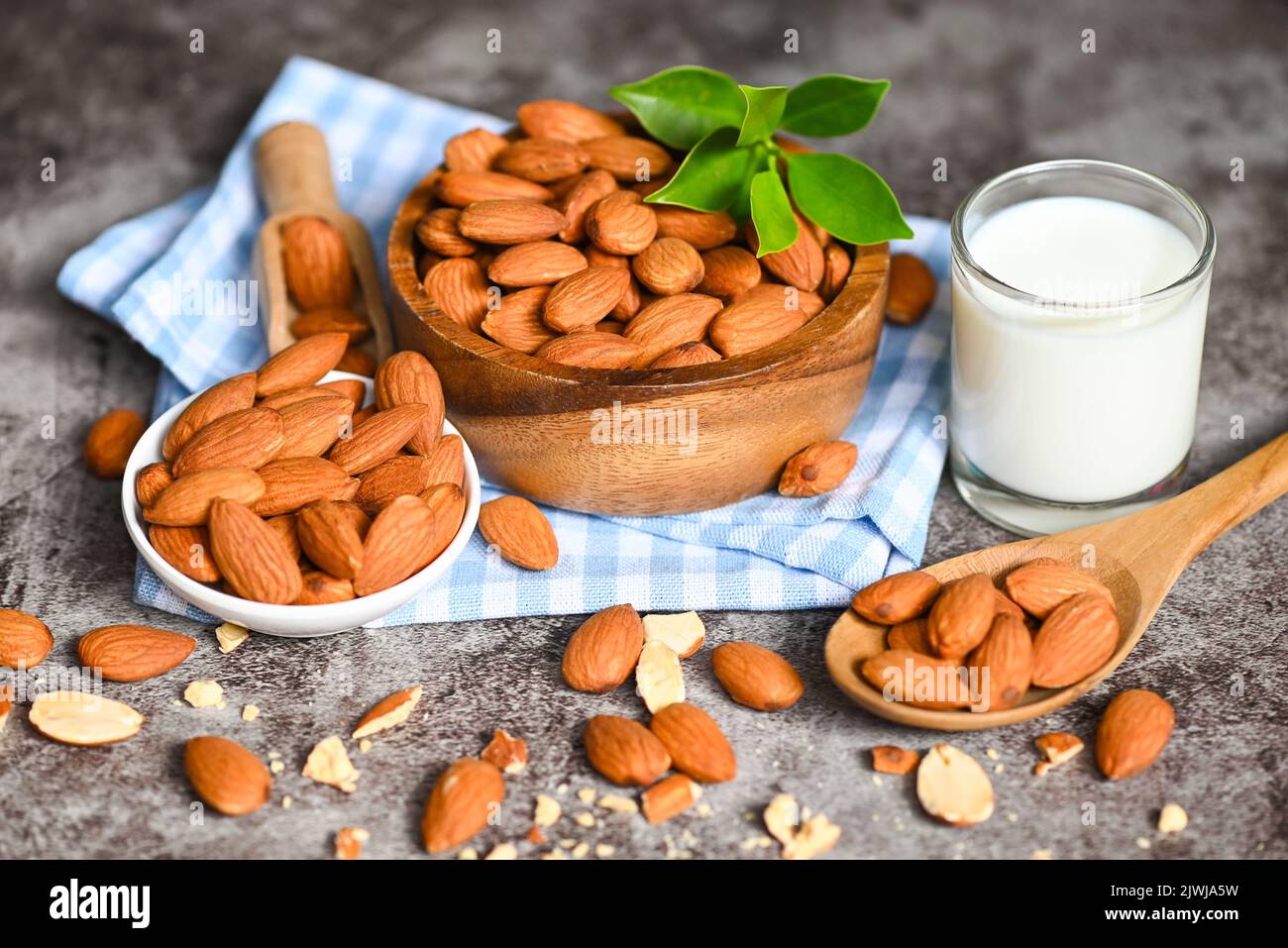 Almond milk and Almonds nuts on bowl background, Delicious sweet almonds on the table, roasted almond nut for healthy food and snack Stock Photo