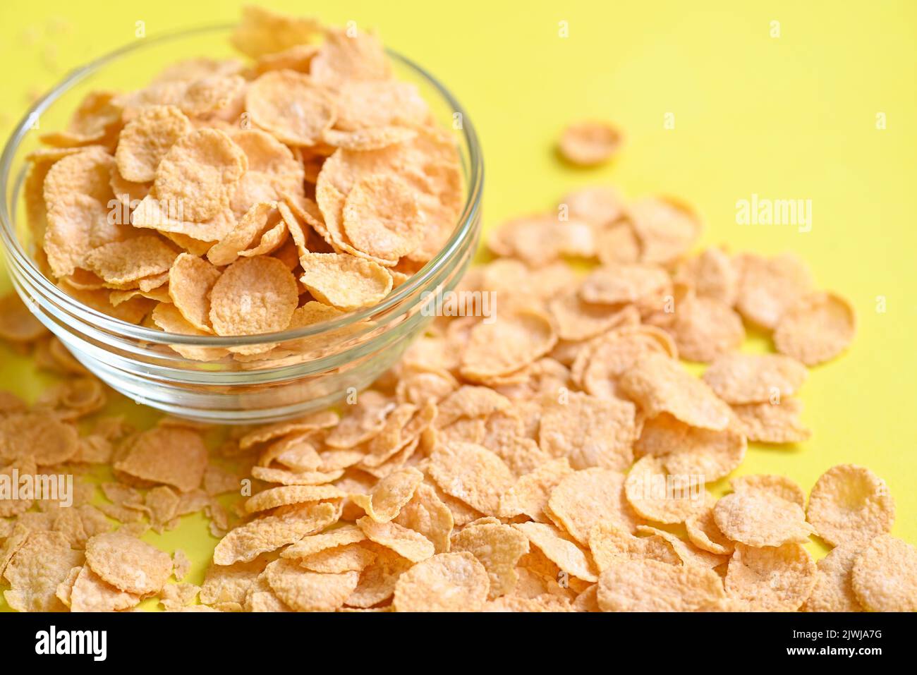 cornflakes bowl breakfast food and snack for healthy food concept, morning breakfast fresh whole grain cereal, cornflakes on yellow background Stock Photo