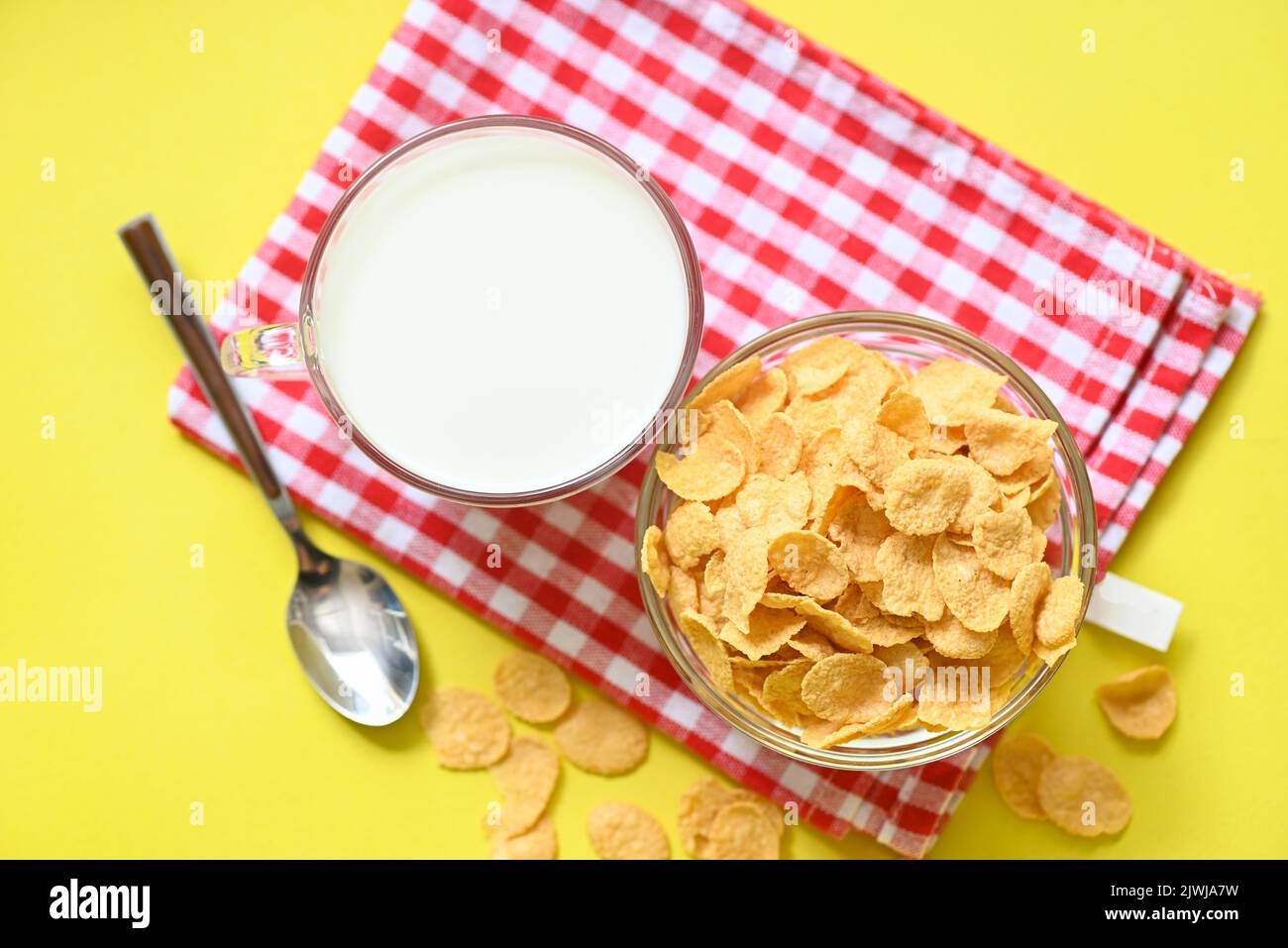 cornflakes bowl breakfast food and snack for healthy food concept, morning breakfast fresh whole grain cereal, cornflakes with milk on yellow backgrou Stock Photo