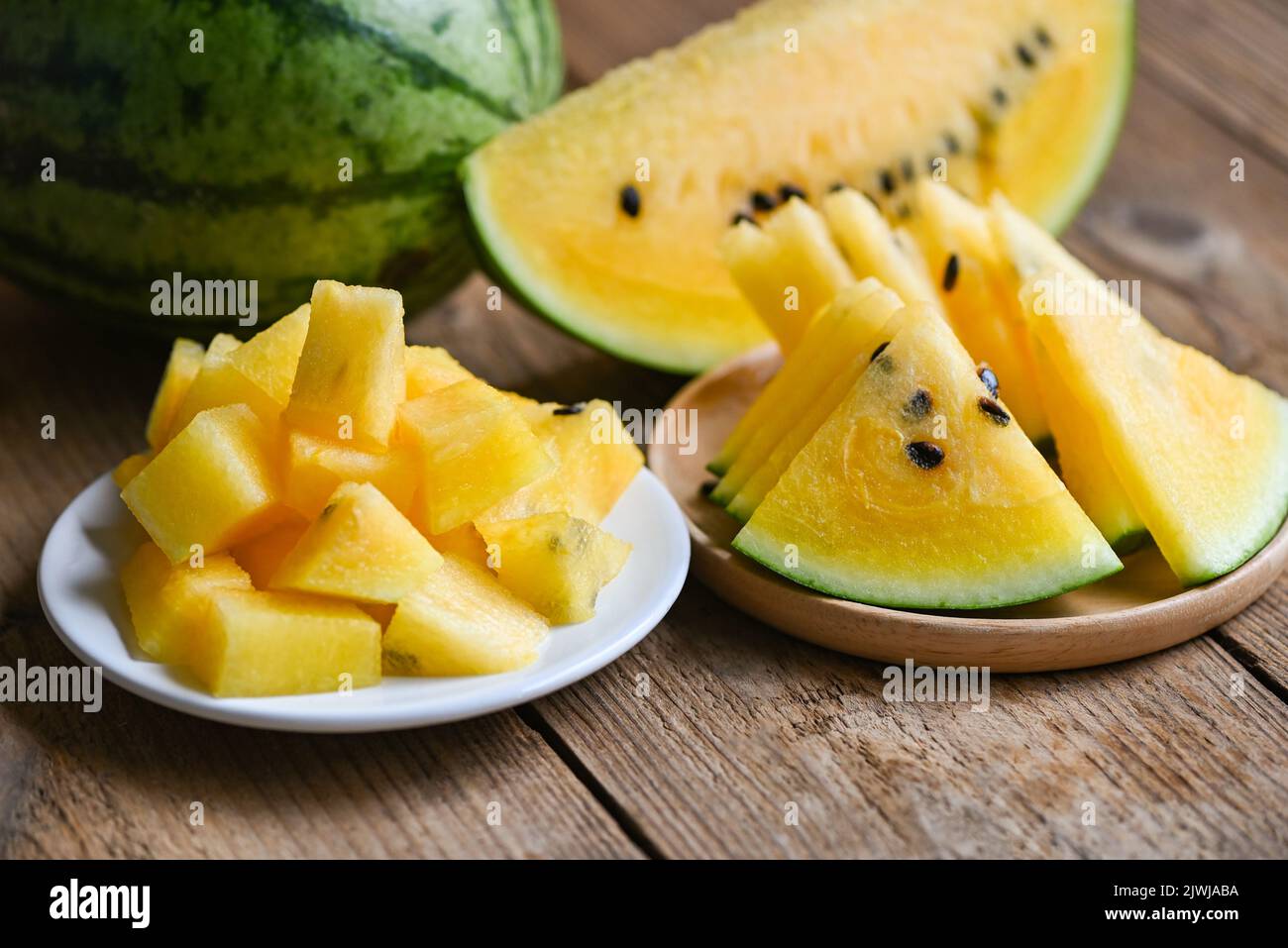 Yellow watermelon slice on plate, Closeup pile of sweet watermelon slices pieces fresh watermelon tropical summer fruit Stock Photo