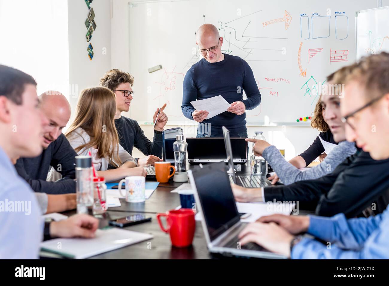 Startup business and entrepreneurship problem solving. Young AI programmers and IT software developers team brainstorming and programming on desktop Stock Photo