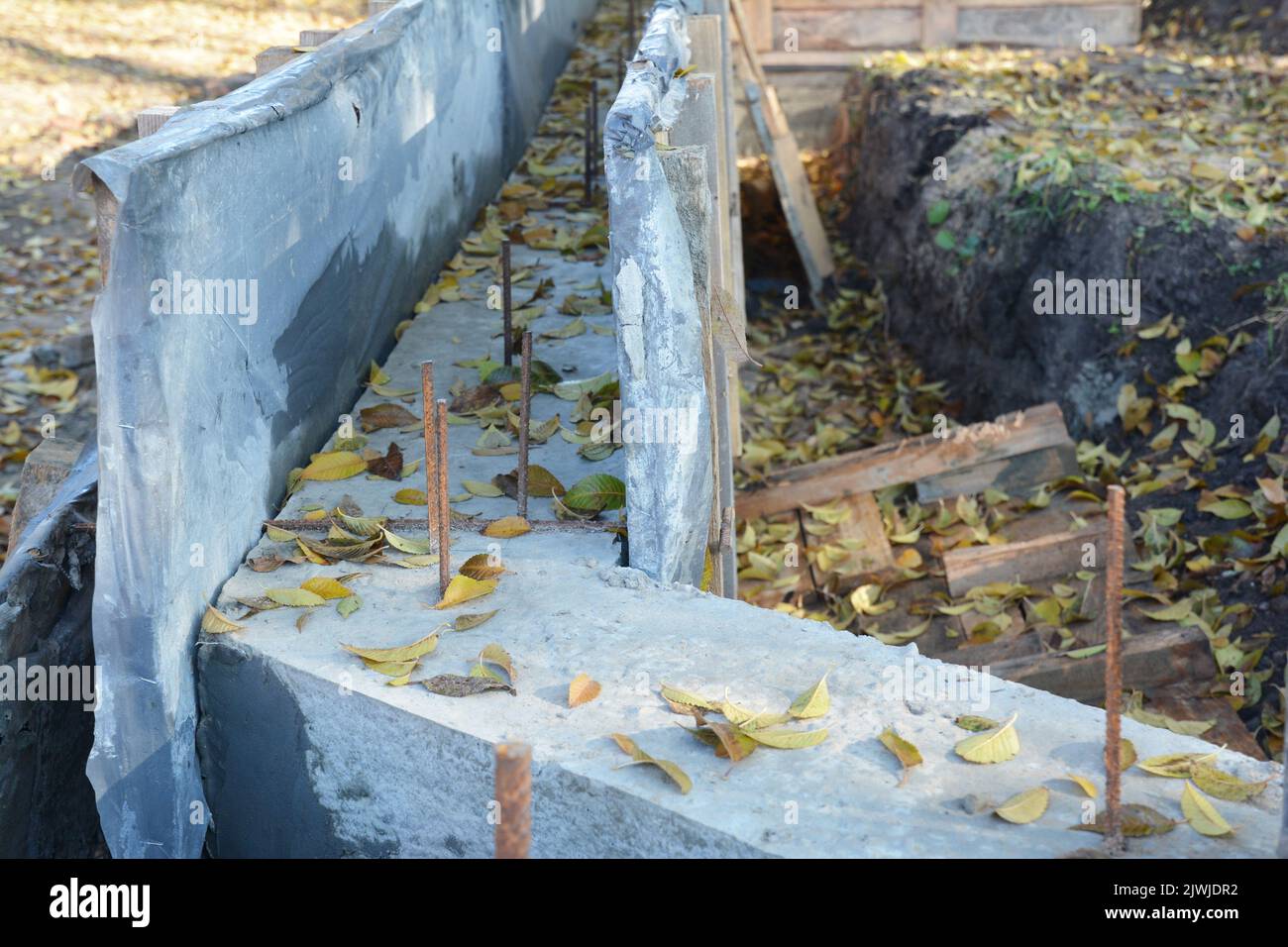 A close-up of the concrete footing in concrete forms with reinforcement