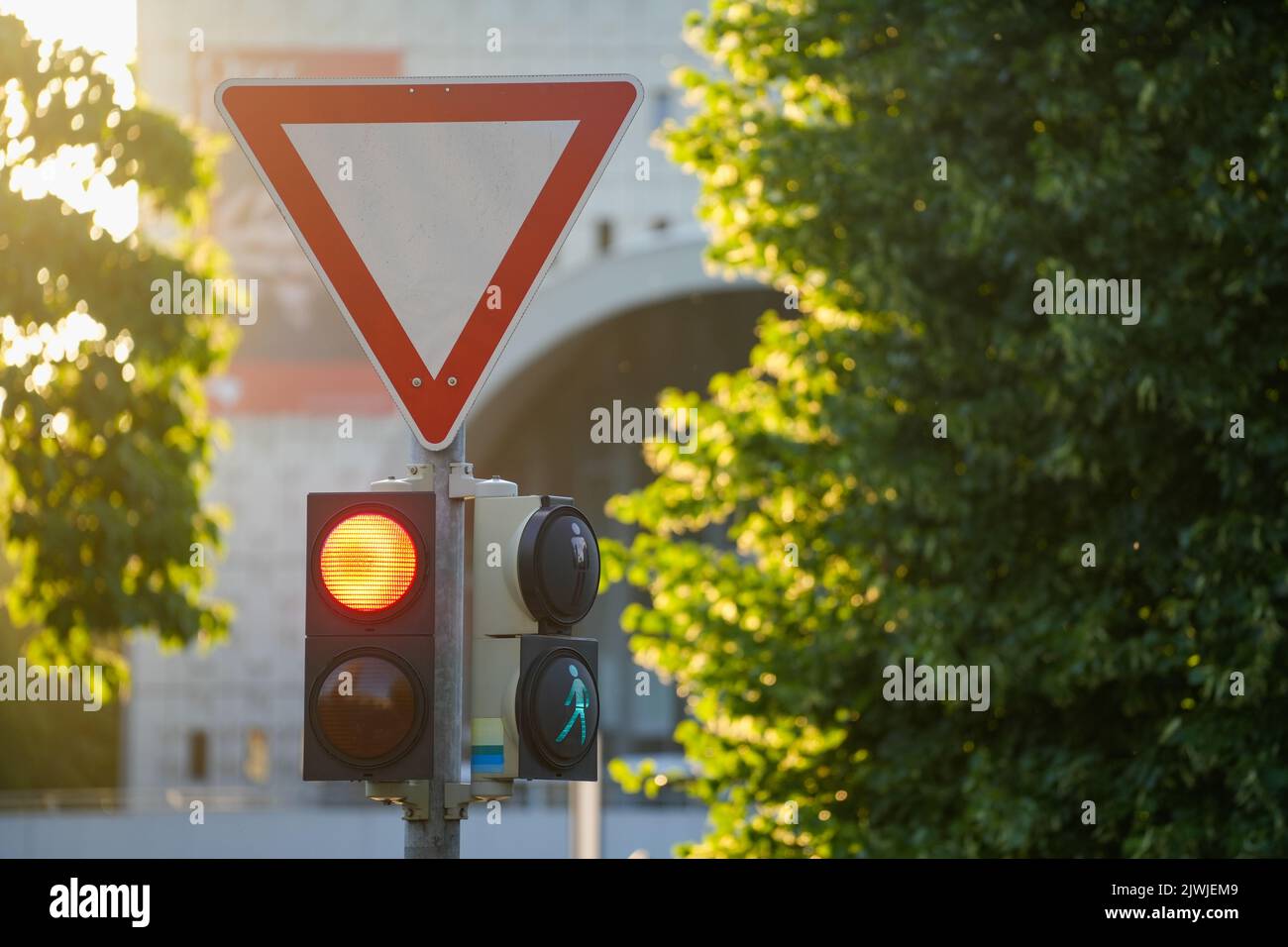 The traffic lights with yellow light on vertical pole Stock Photo - Alamy