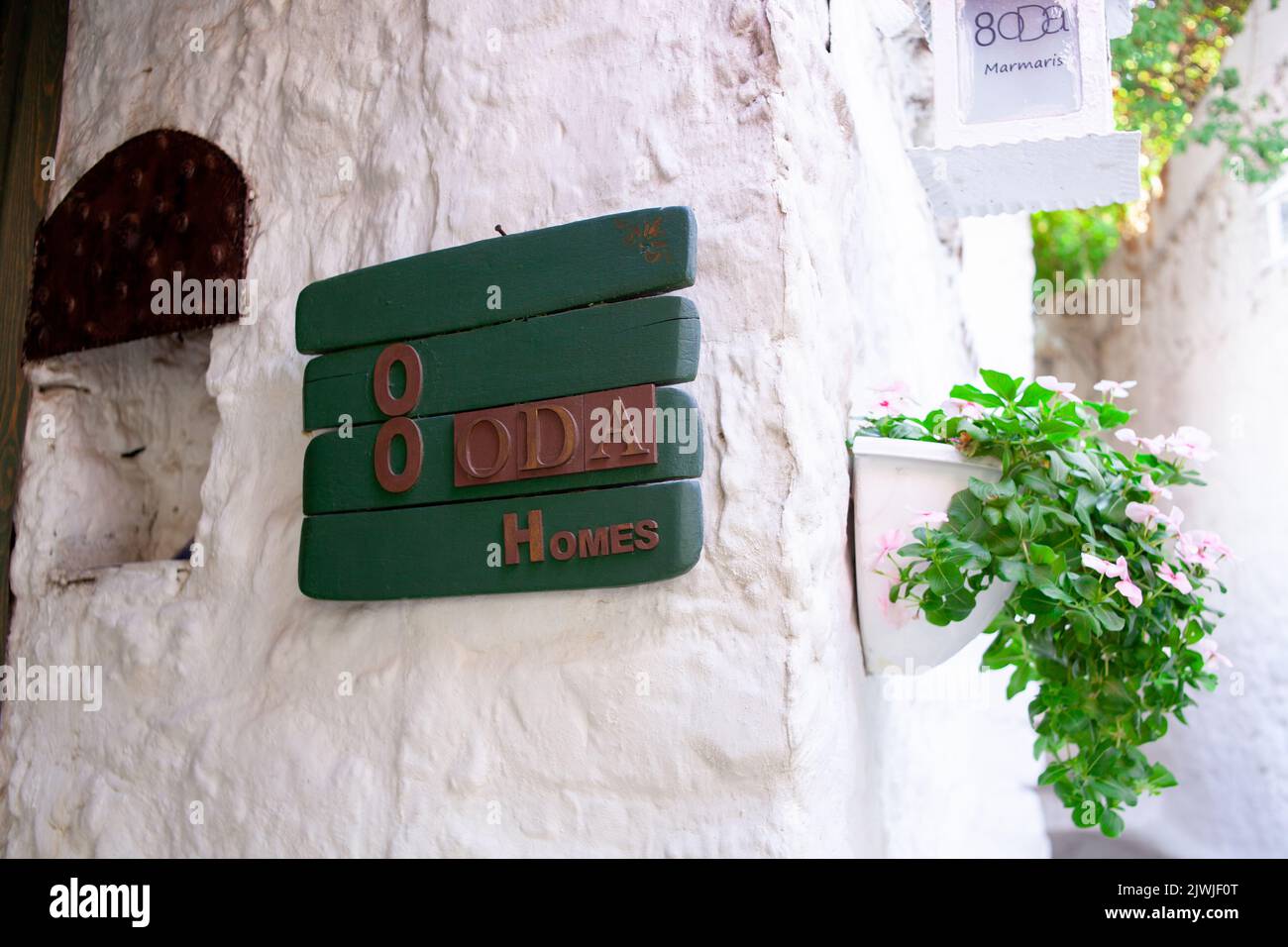 House number plate on a wall. Address number on white wall in old town