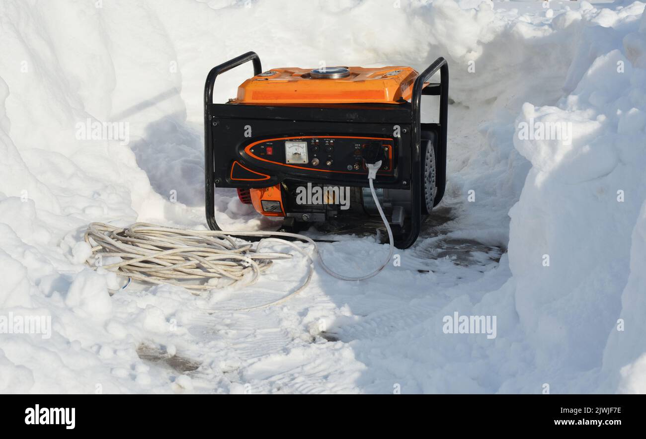 A mobile portable backup generator on the snow after a winter storm