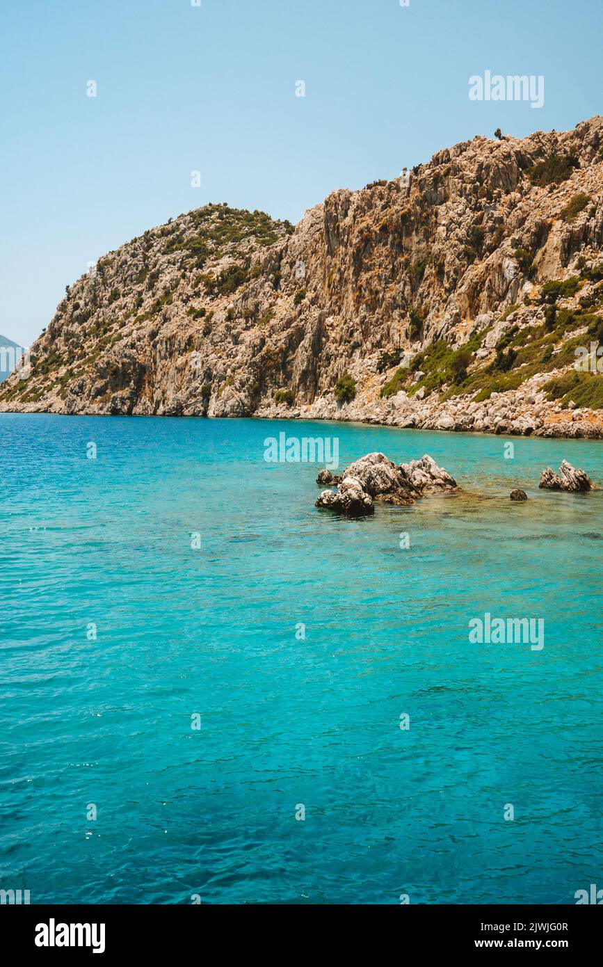 Aegean sea reef and hill landscape in Turkey turquoise water resort travel destination nature beautiful scenery summer season Stock Photo