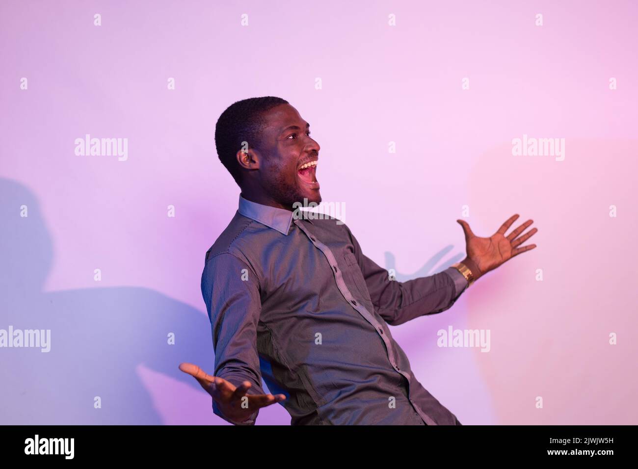 Excited african man gesturing hi-res stock photography and images - Alamy