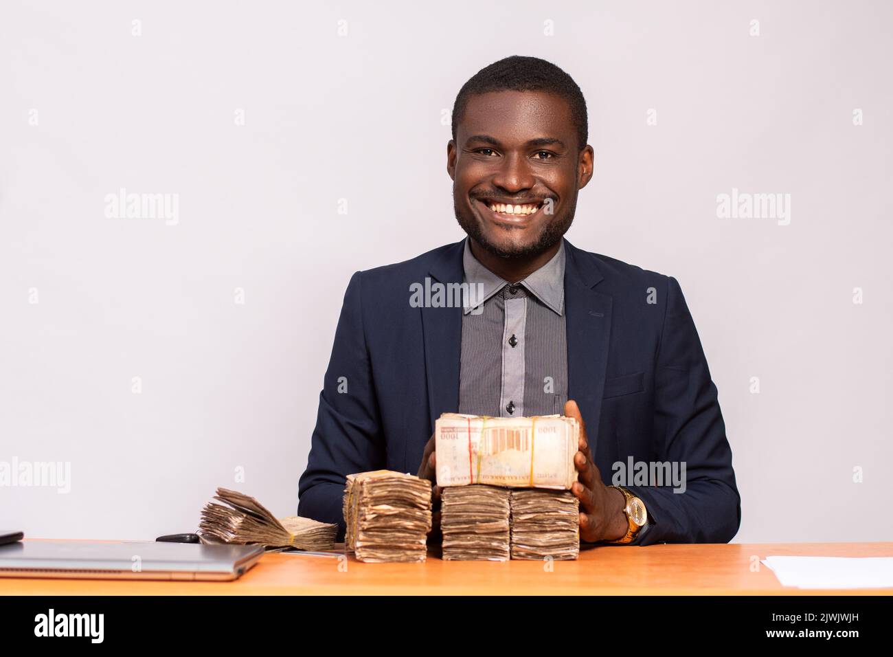 african businessman with lots of money smiling Stock Photo - Alamy