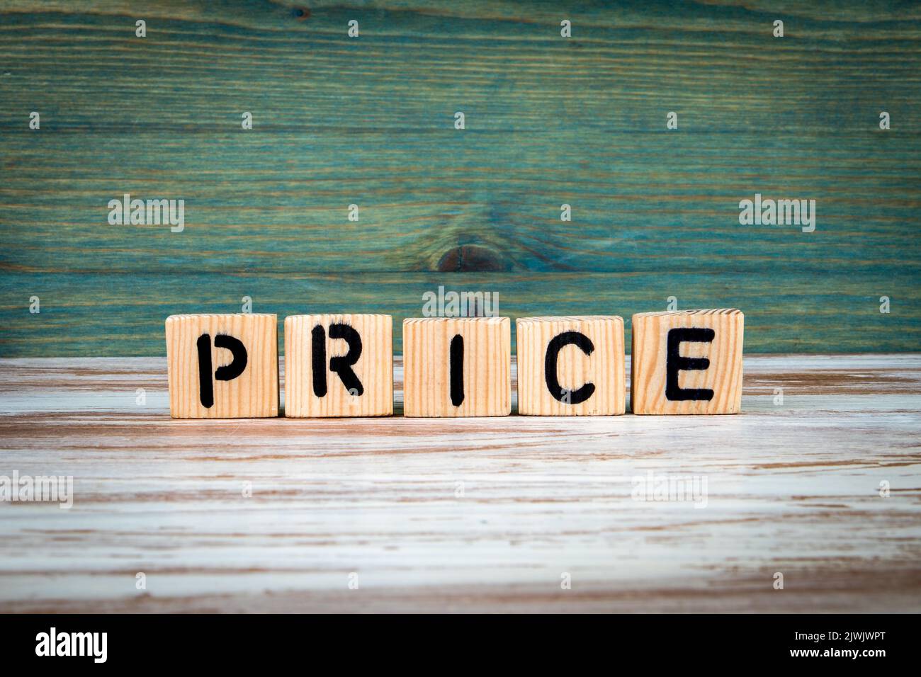PRICE concept. Alphabet wooden blocks on green and white background. Stock Photo