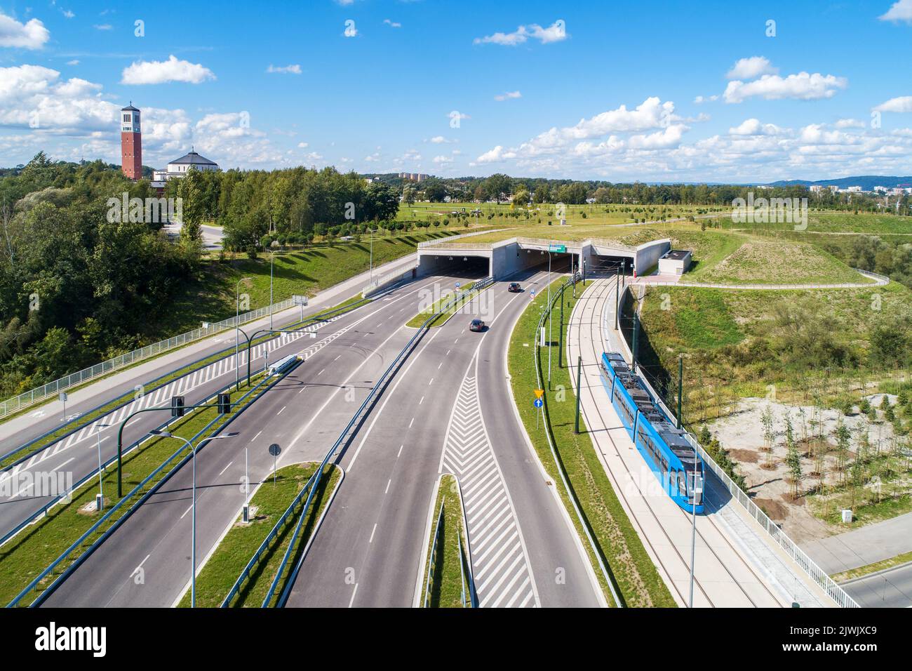New city highway in Krakow, Poland, called Trasa Łagiewnicka with separate tunnels for cars and tramway with traffic and tram.  Part of the ring road Stock Photo