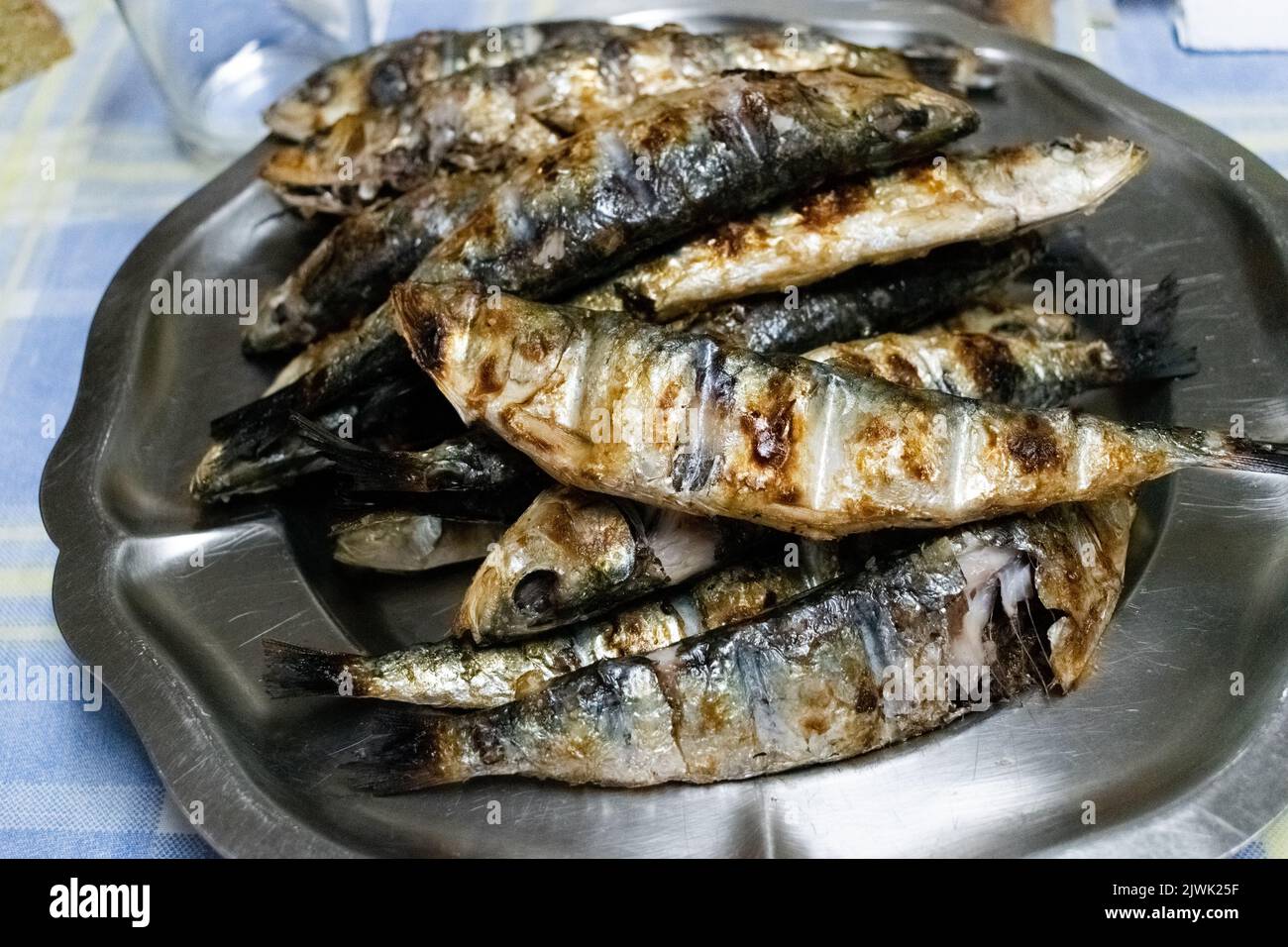 Grilled sardines on a metal platter Stock Photo