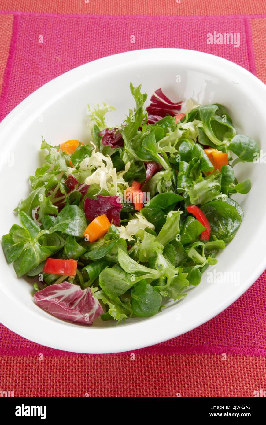 Crispy leaf salad in a white bowl from above Stock Photo