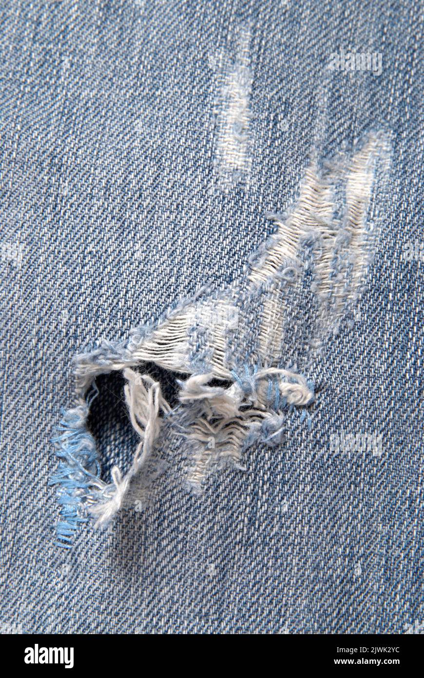 Close up detail of torn denim jeans background Stock Photo