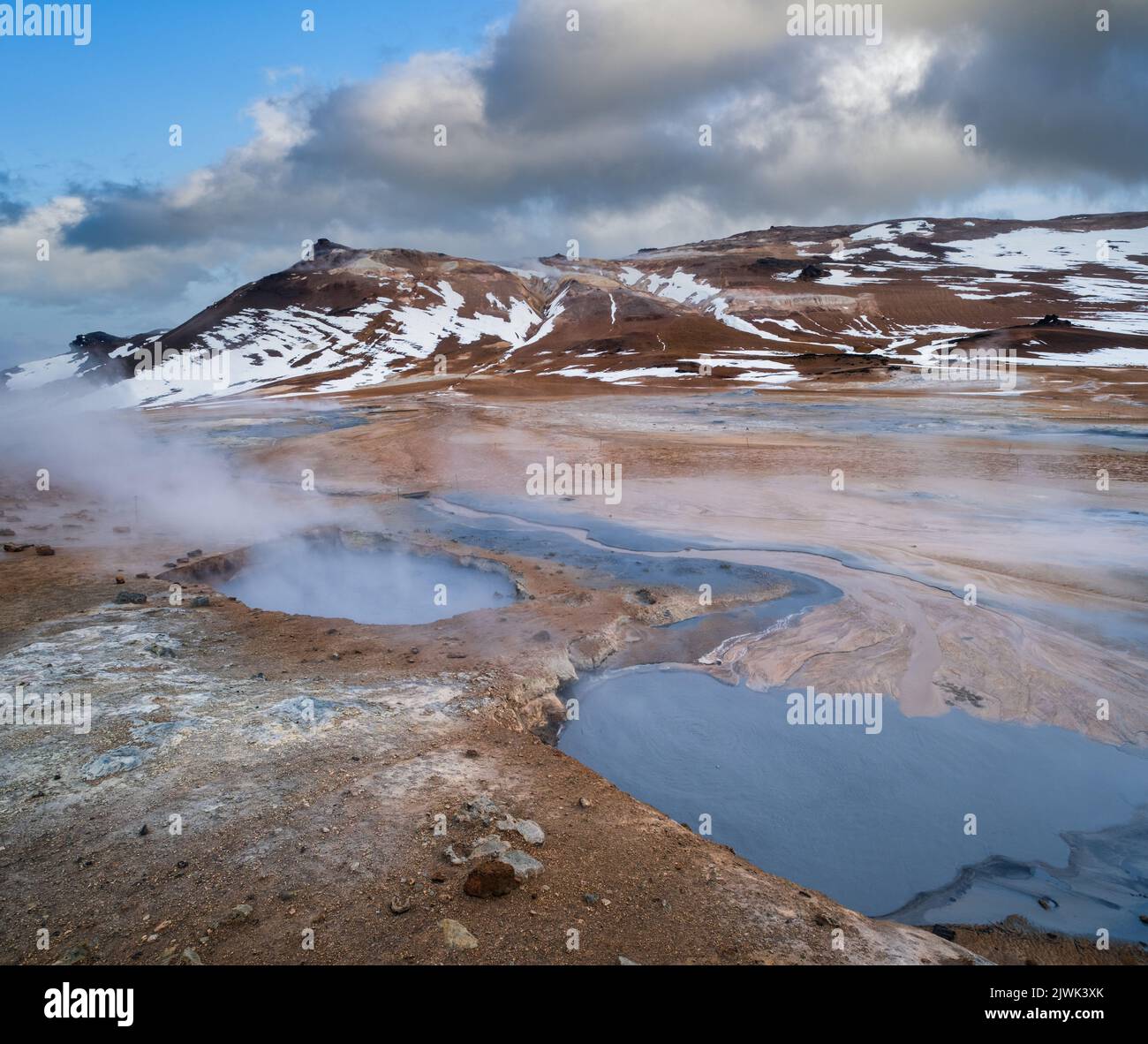 The Namafjall Geothermal Area, Iceland, on the east side of Lake Myvatn. At this area, also known as Hverir, are many smoking fumaroles, boiling mud p Stock Photo