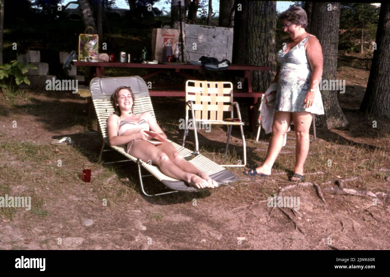 Two women enjoying sunbathing in the countryside c1965 Photo by Tony Henshaw Archive Stock Photo