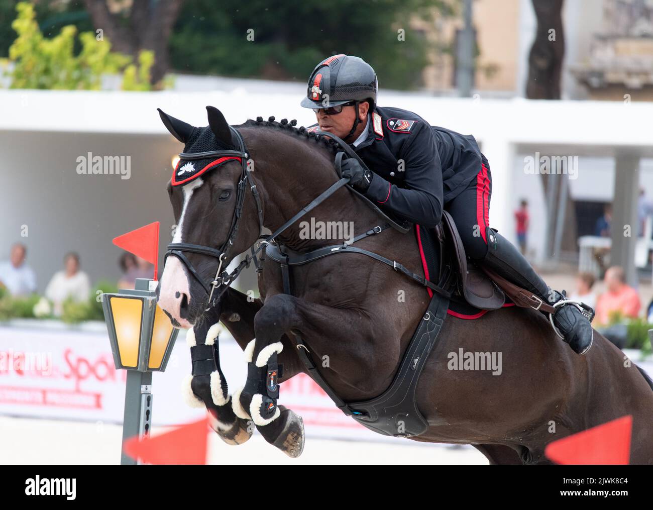 Military sportsman riding horse jumping during equestrian competition. Rome, Italy, 2-4 september 2022, Equestrian Jumping Championship Stock Photo