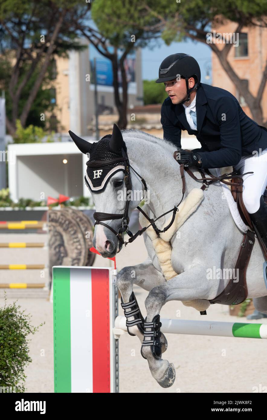 Man riding horse and jumping during equestrian competition close up detail, Italy, 2-4 september 2022, Equestrian Jumping Championship Stock Photo