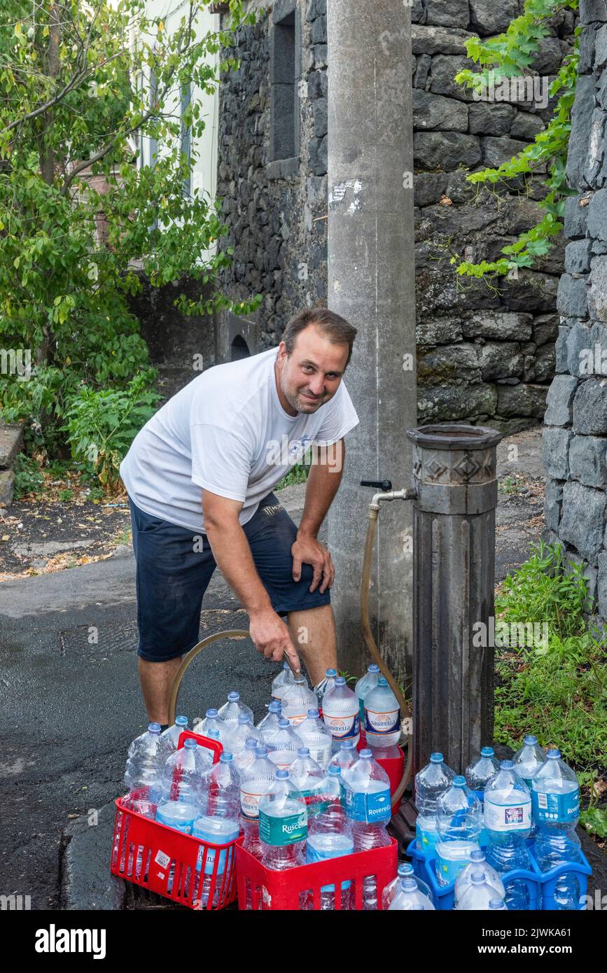 https://c8.alamy.com/comp/2JWKA61/refilling-water-bottles-with-delicious-fresh-drinking-water-from-a-public-fountain-in-the-sicilian-village-of-milo-high-on-the-slopes-of-mount-etna-2JWKA61.jpg