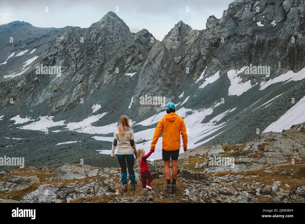 Family hiking parents holding hands with child travel vacation in mountains camping outdoor adventure active healthy lifestyle father and mother with Stock Photo