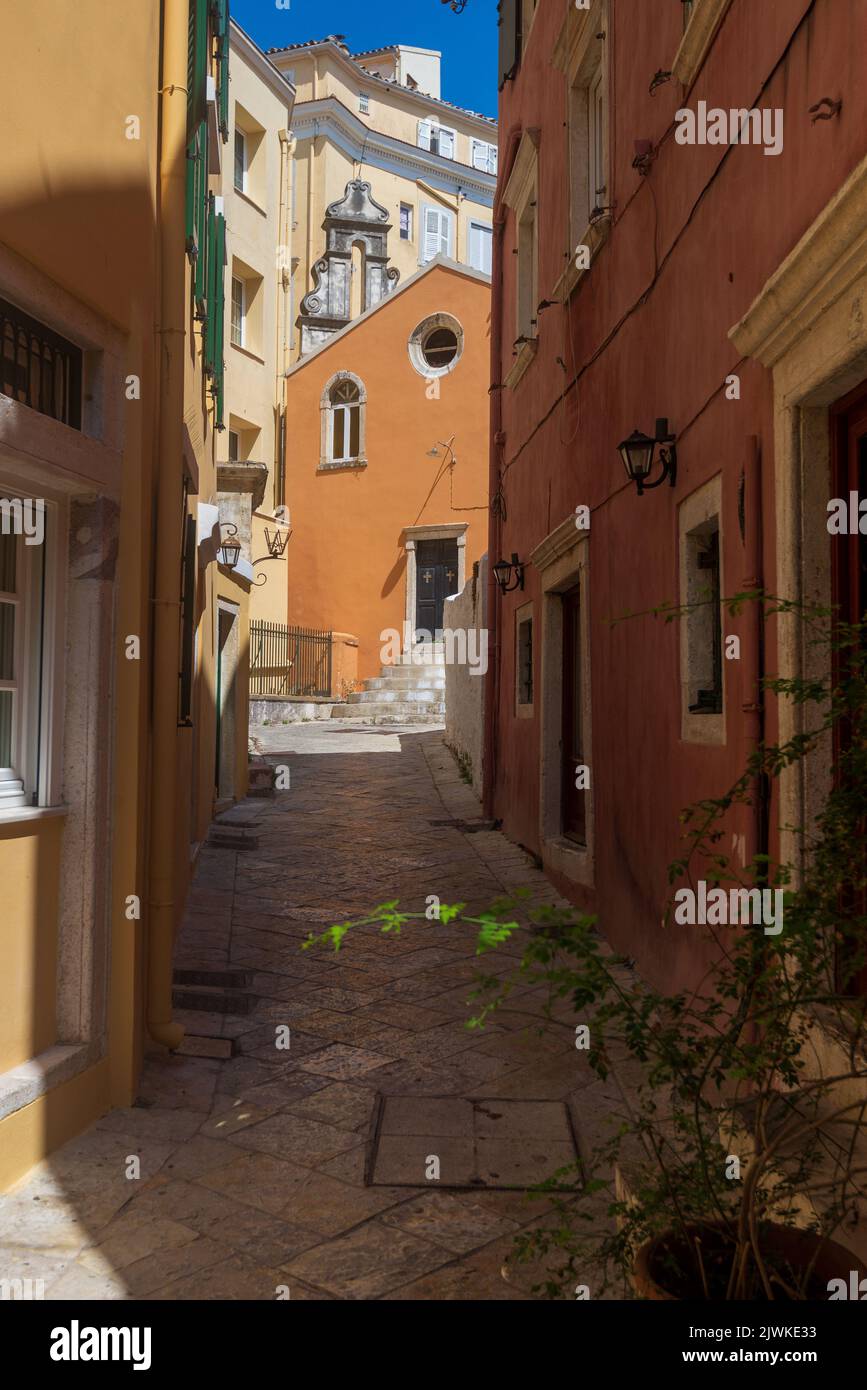 The exterior of a church in Corfu Town viewed up an alleyway Stock Photo