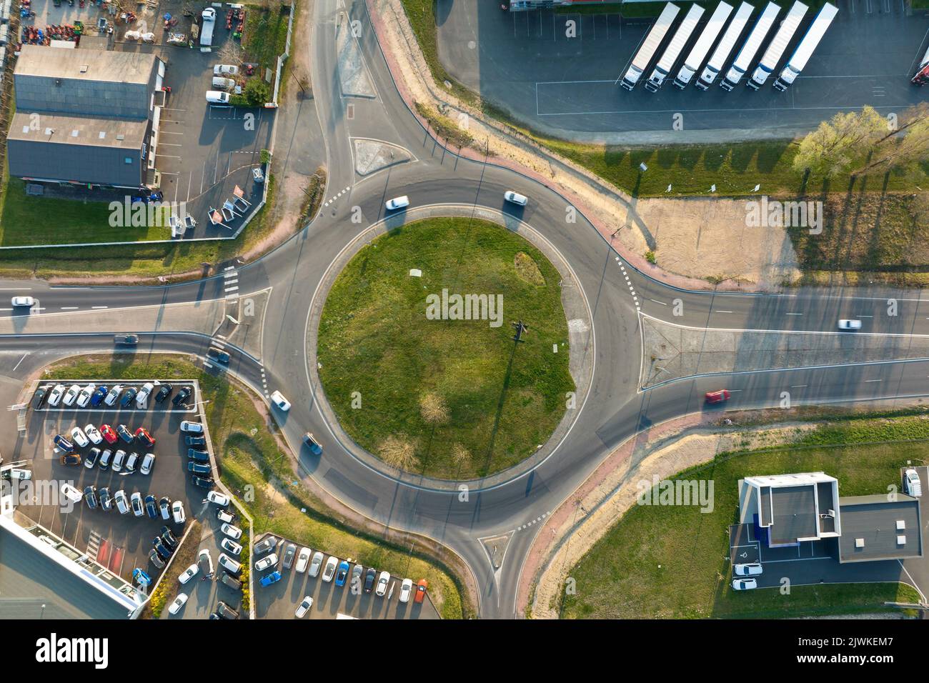 Aerial view of road roundabout intersection with moving heavy traffic ...