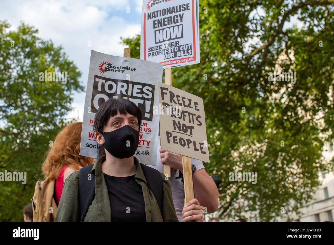 London, England, UK. 5th Sep, 2022. A protester holds a sign which reads ''Freeze profits not people ''. Protesters gather outside Downing Street. Stock Photo