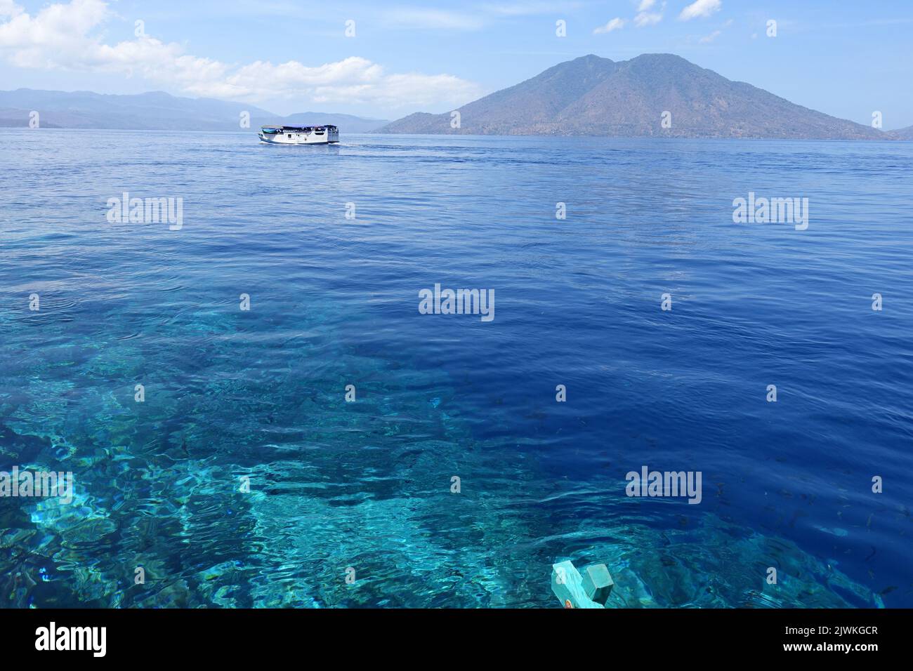 Indonesia Alor Island - Reef edge and local ferry Stock Photo
