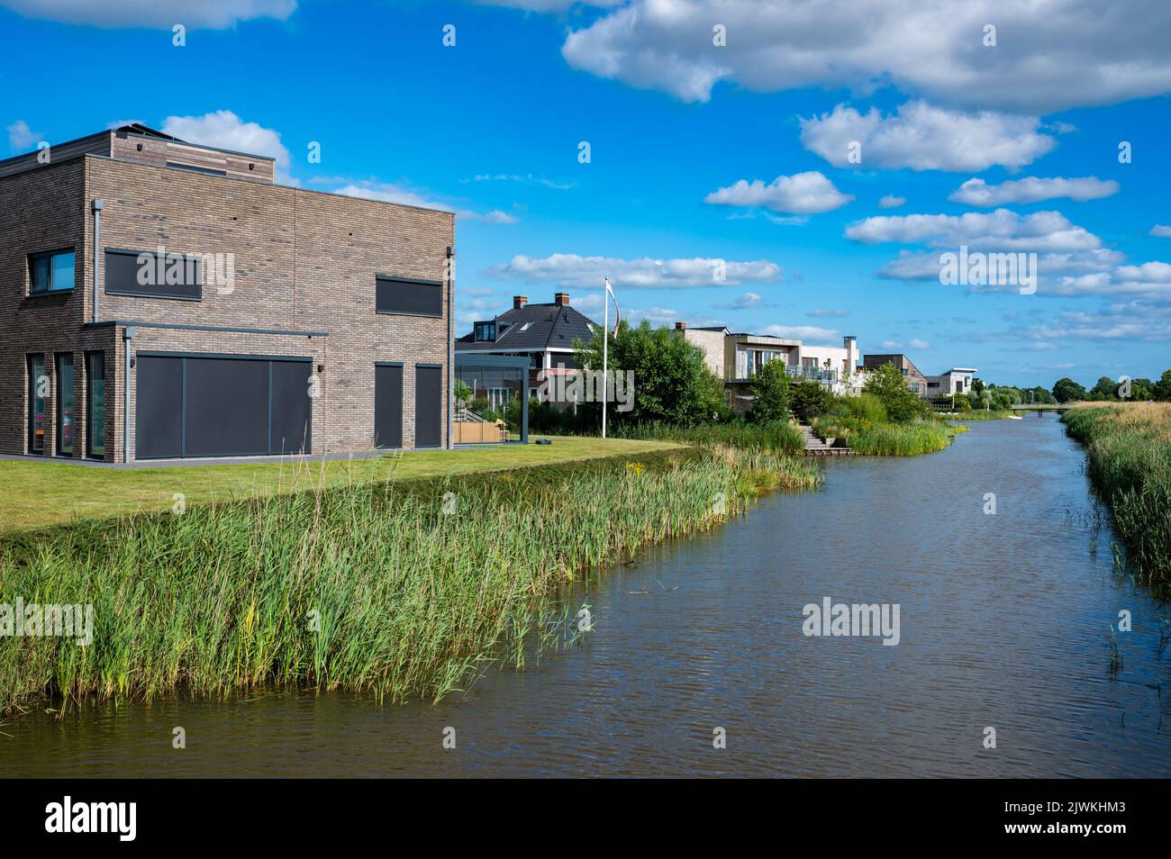 Groningen, The Netherlands, 07 20 2022 Contemporary country style houses at the waterfront