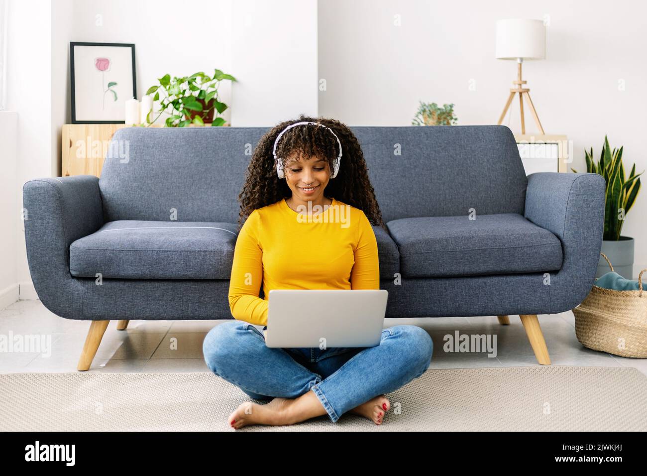 Millennial student adult woman using laptop computer at home Stock Photo