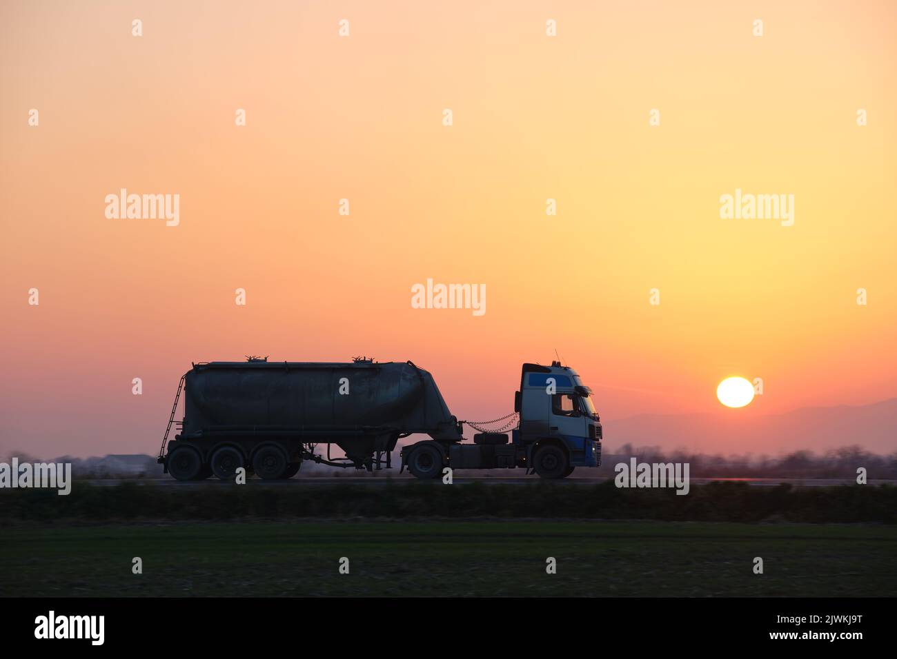 Petrol cargo truck driving on highway hauling oil products. Delivery
