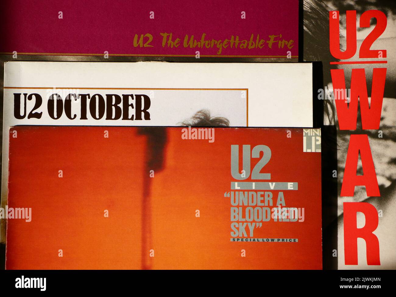 Photo of album covers of original pressings of vinyl discs by U2 The Unforgettable Fire October U2 Live Under a Blood Red Sky and War Stock Photo