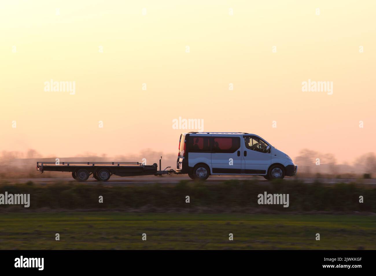 Tow truck vehicle with car carrier trailer driving on highway in ...