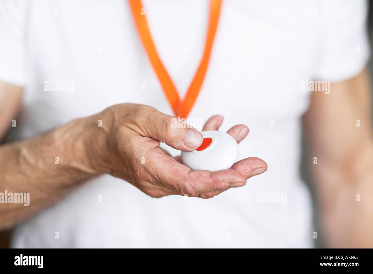 Unrecognizable senior man pushing panic button on emergency equipment Stock Photo