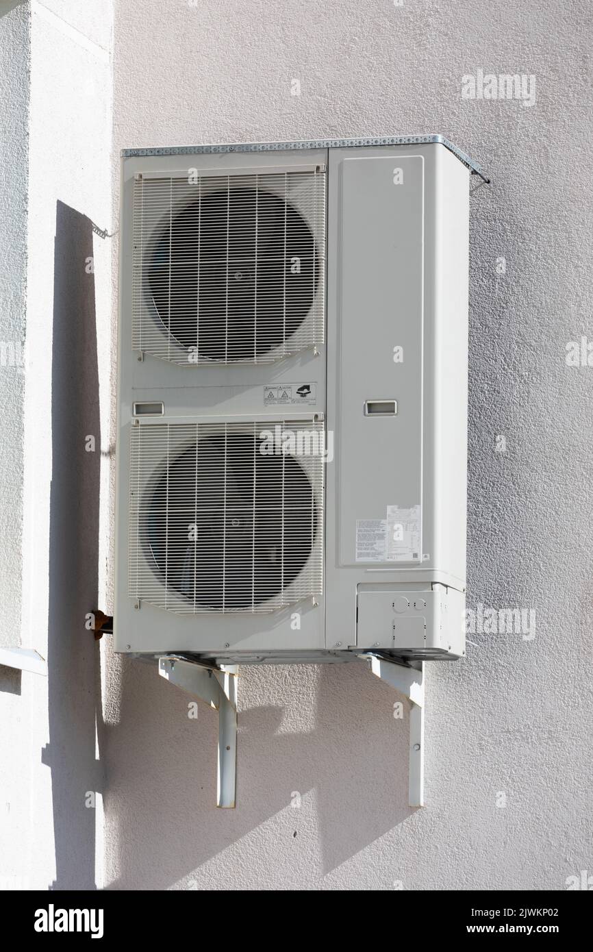 outdoor air conditioner unit with heat exchanger hanging outside the