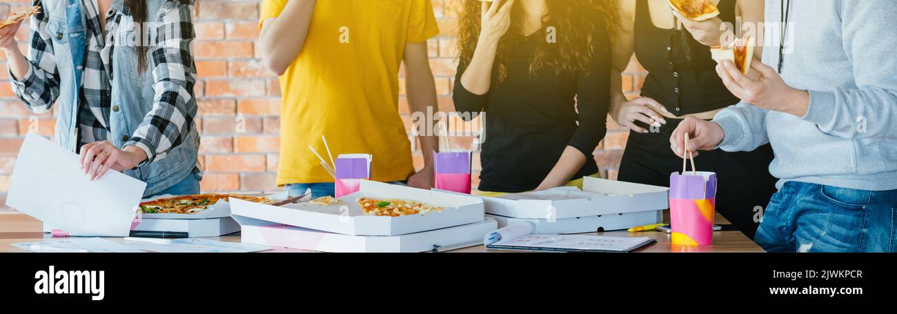 youth lifestyle working talking eating pizza tasty Stock Photo