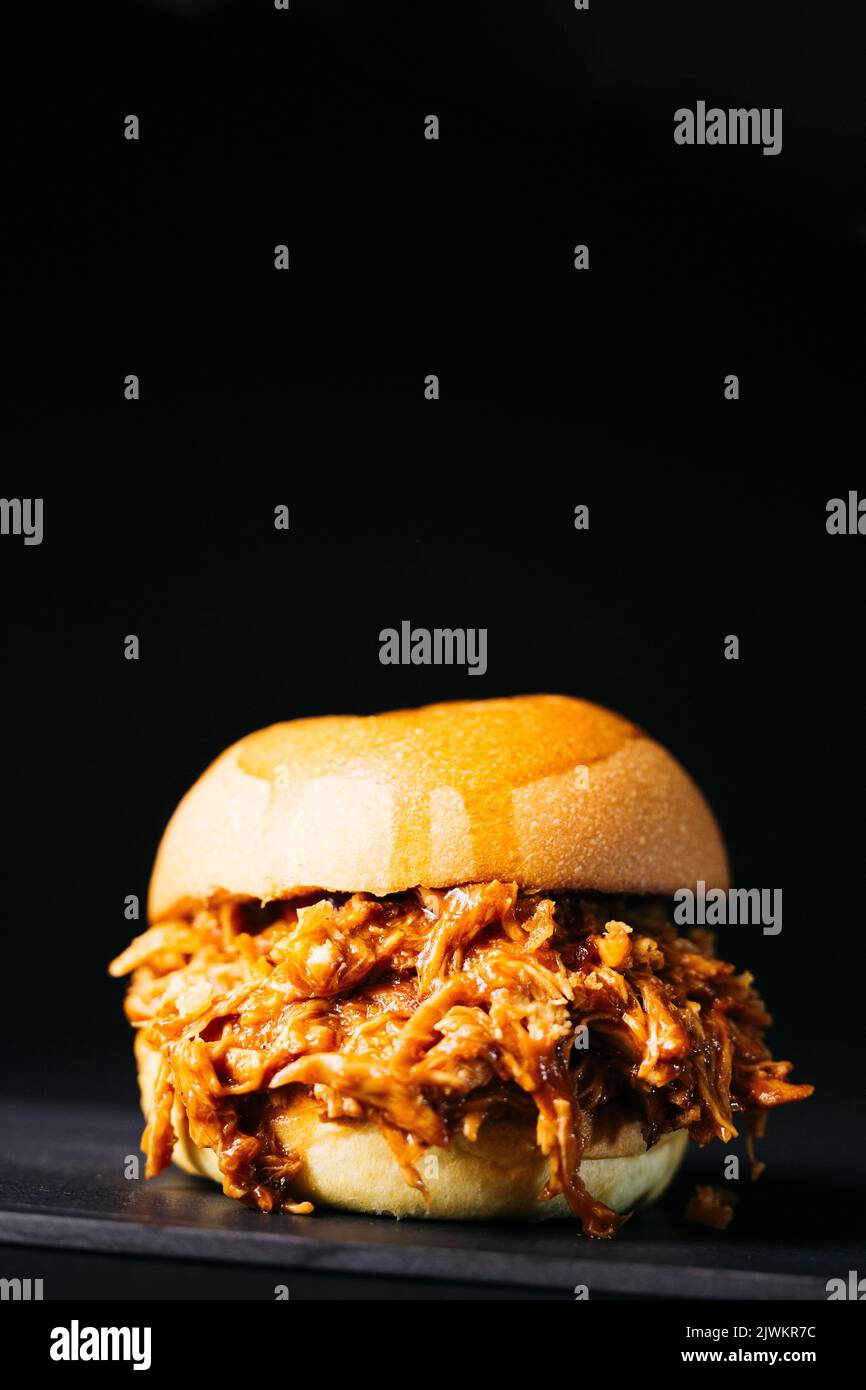 Pulled chicken burger over a black background Stock Photo