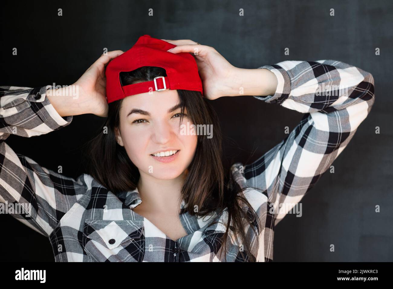 young woman carefree millennial relaxed smile red Stock Photo