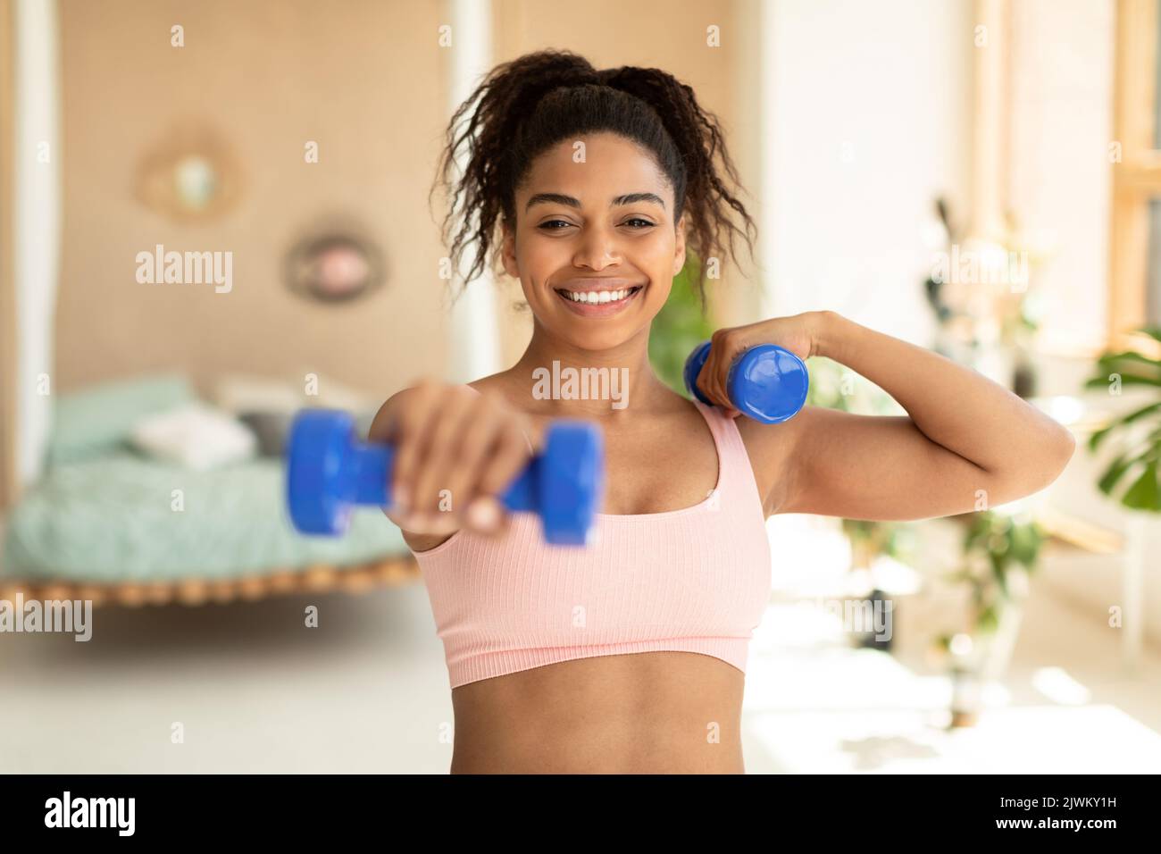 Beautiful healthy happy smiling black asian woman with dumbbell weight  workout and toned body Stock Photo - Alamy