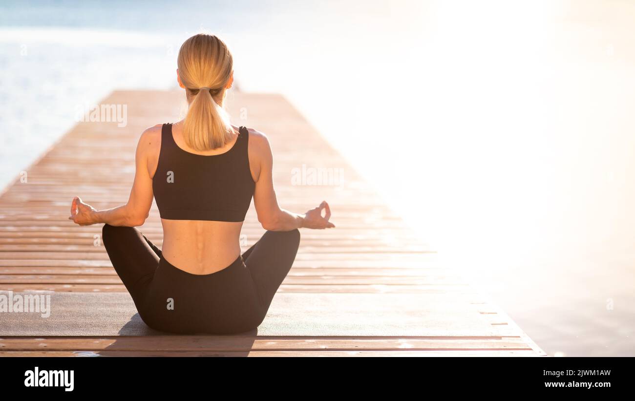 Life Harmony. Rear View Of Slim Female Meditating Outdoors Near The Sea Stock Photo
