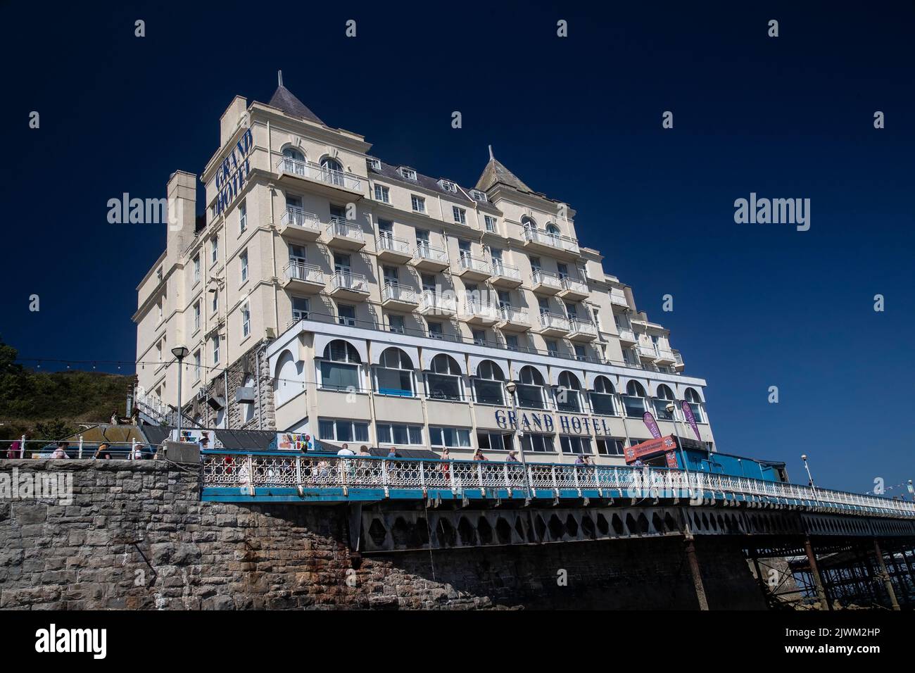 An unusual view of Llandudno's Grand Hotel taken from the landing stage jetty on the North Shore beach Stock Photo