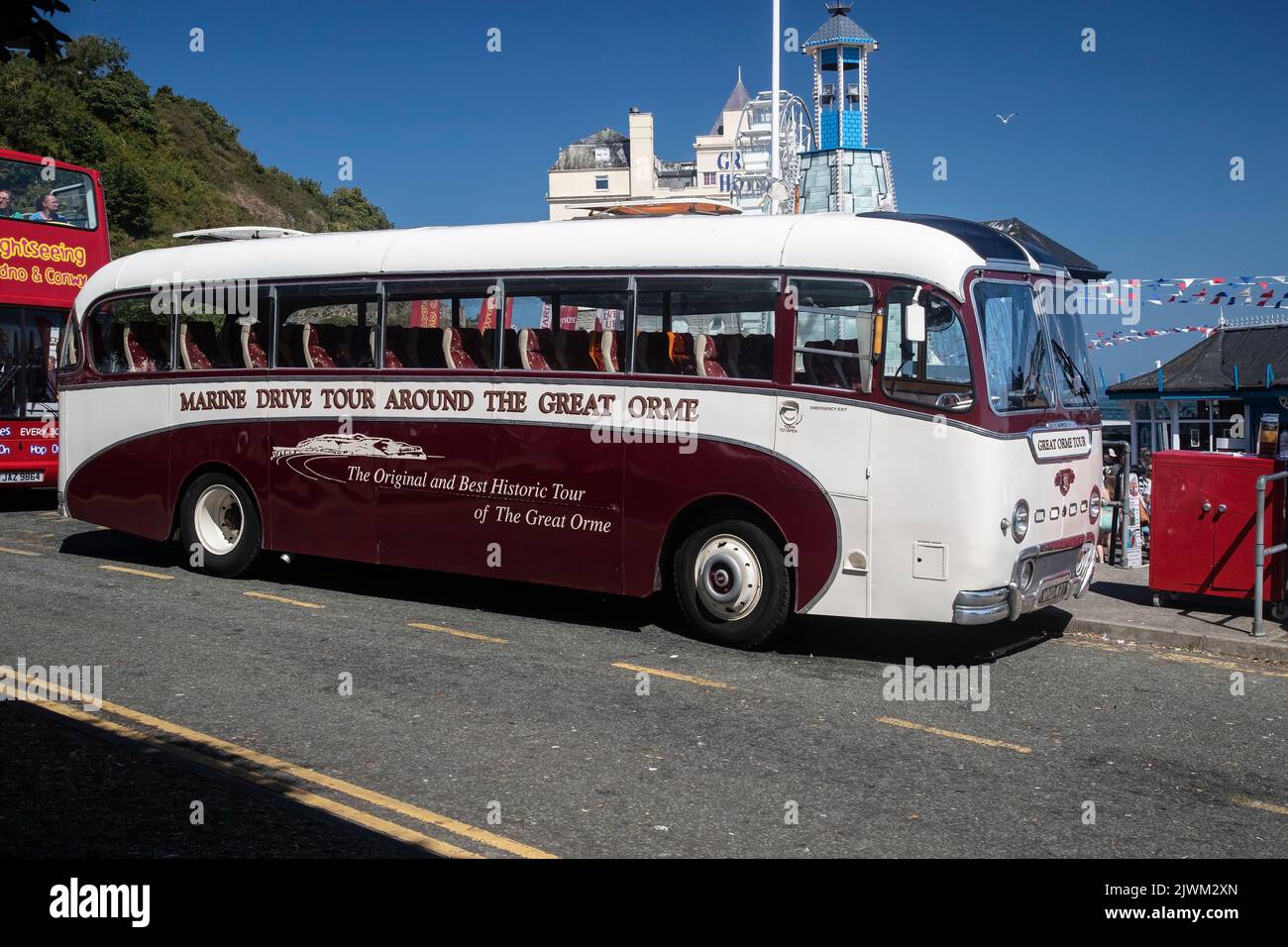 The Vintage Leyland Britannia Tiger Cup Coach opposite Llandudno pier that transports tourists around the Great Orme for sightseeing Stock Photo