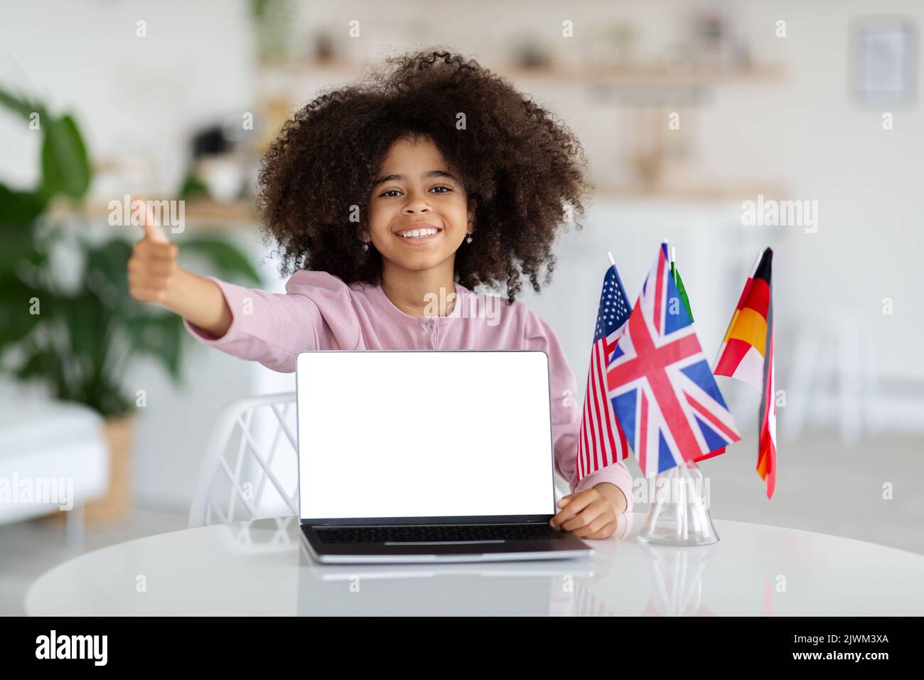 Happy black girl schooler showing laptop and thumb up, mockup Stock ...