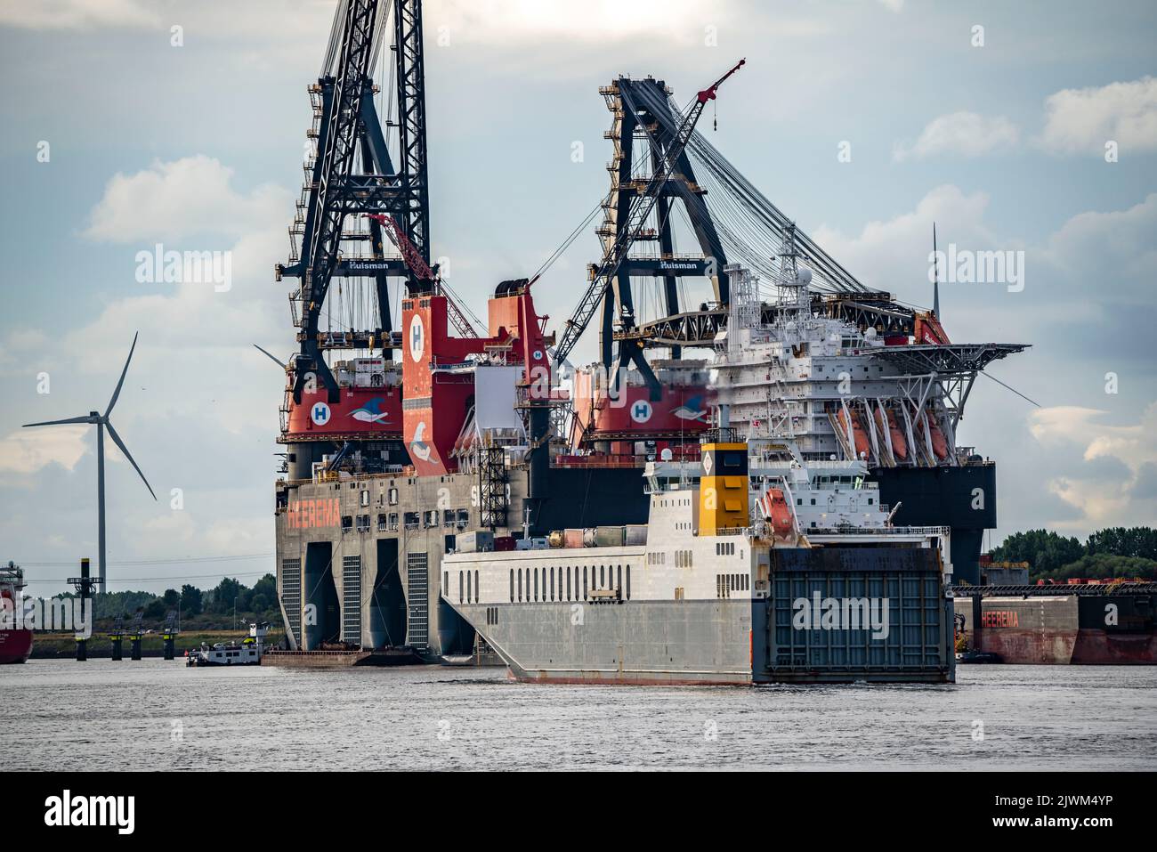 Petroleumhaven, Roro ferry leaving, behind it the largest floating crane in the world, Heerema Sleipnir, from Rotterdam, Netherlands, Stock Photo
