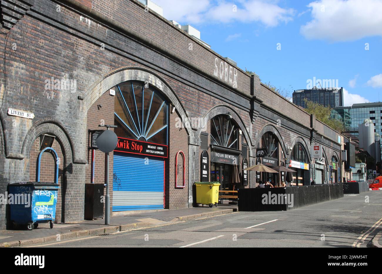Shops, businesses and entrance to Birmingham Snow Hill in railway arches on Livery Street, Birmingham, 19th August 2022. Stock Photo
