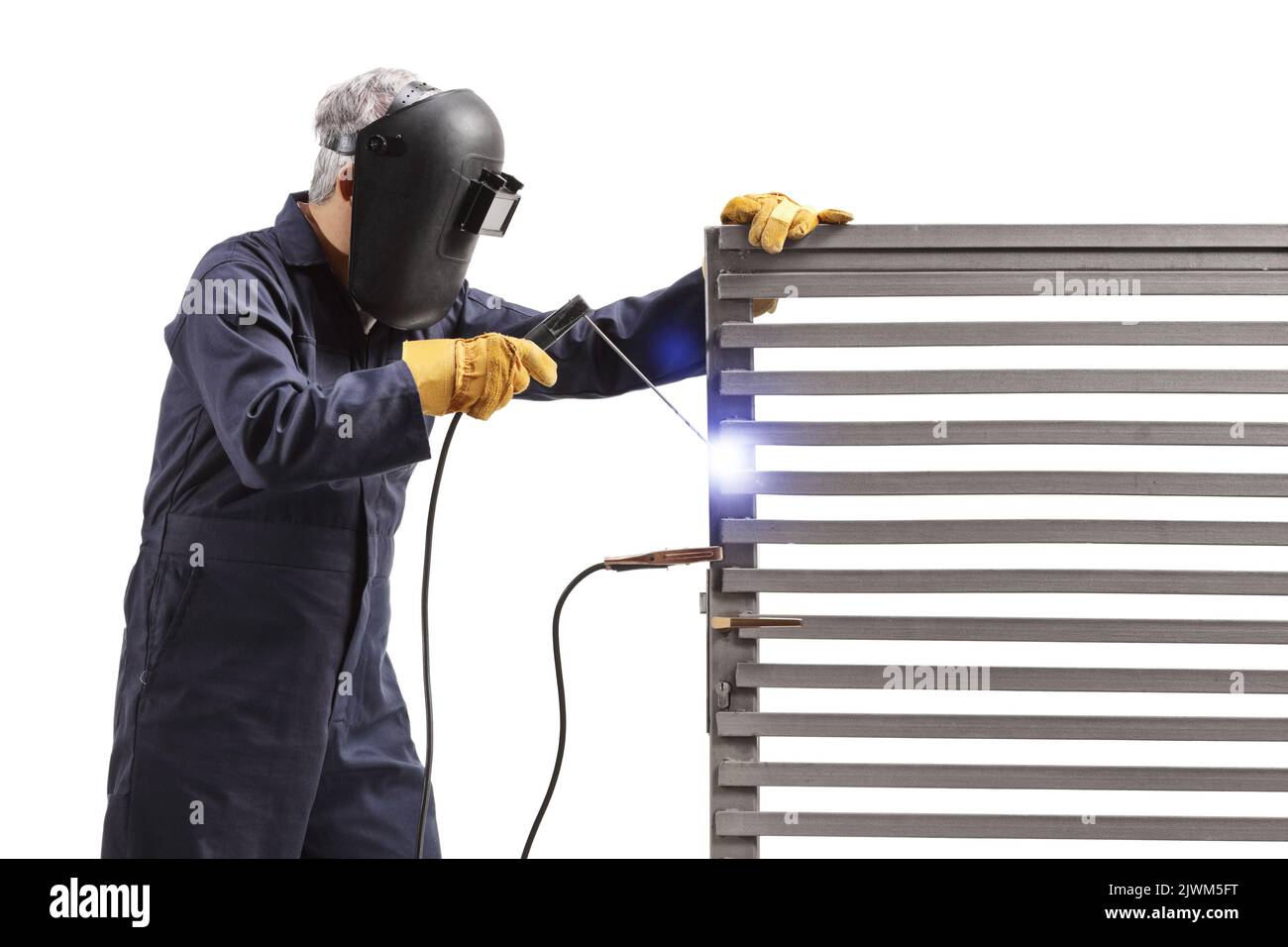 Welder welding a metal door isolated on white background Stock Photo