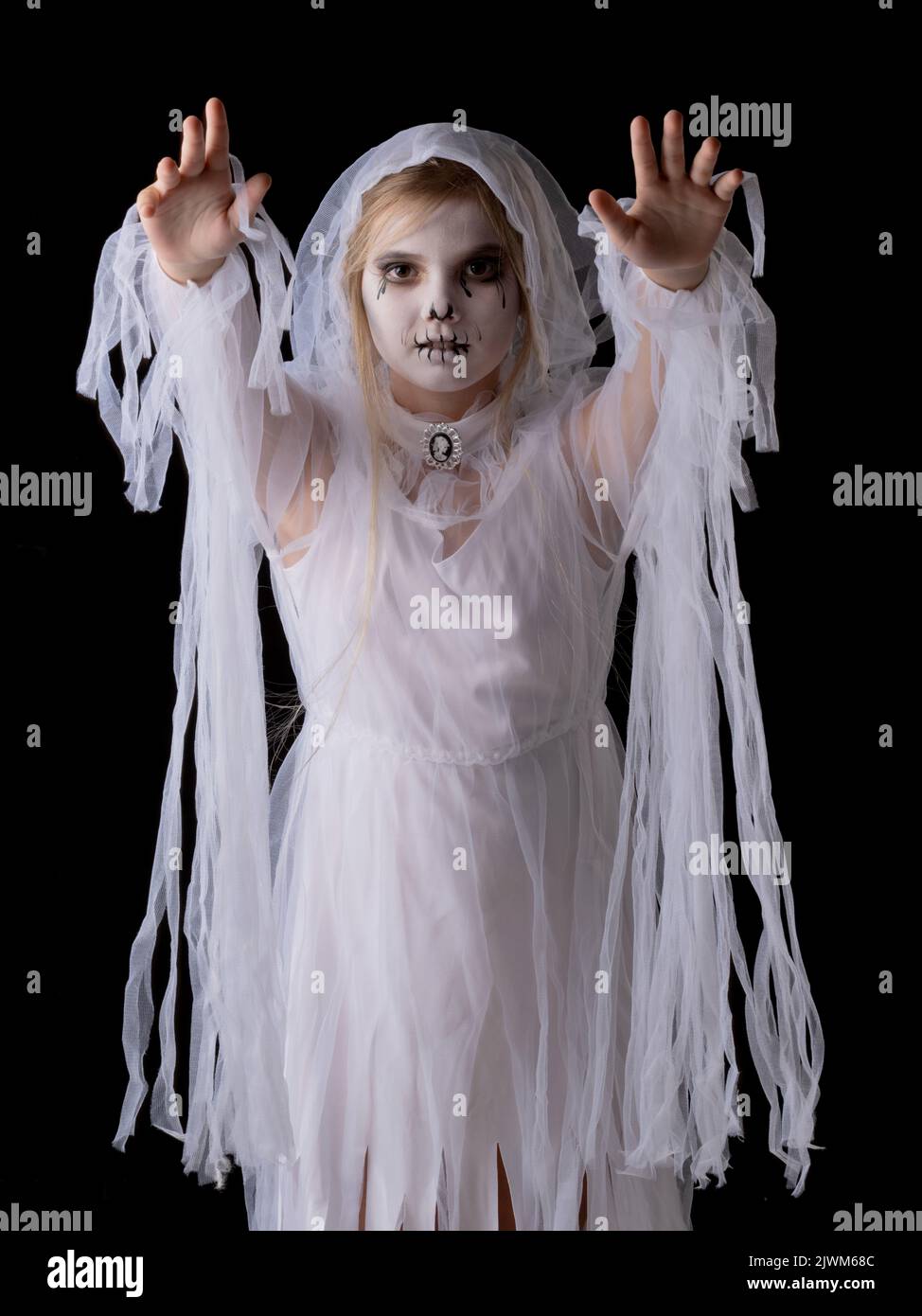 Little girl in Halloween ghost costume walking on you, studio isolated on black background Stock Photo